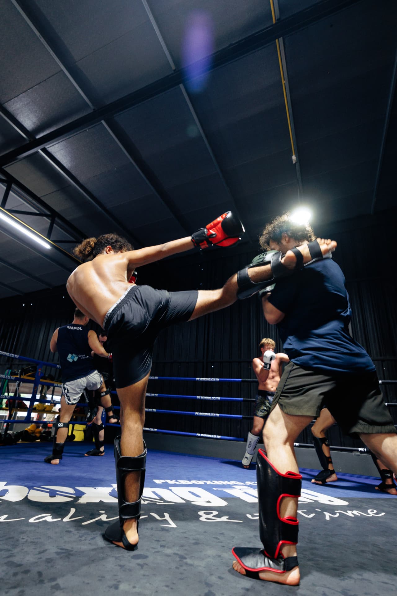 Two fighters sparring in the ring at KRU