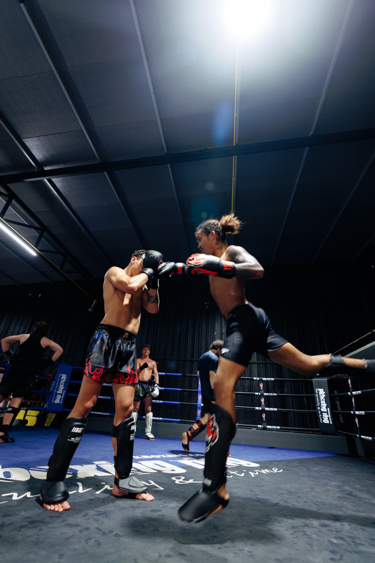 A fighter throwing a jumping knee during sparring