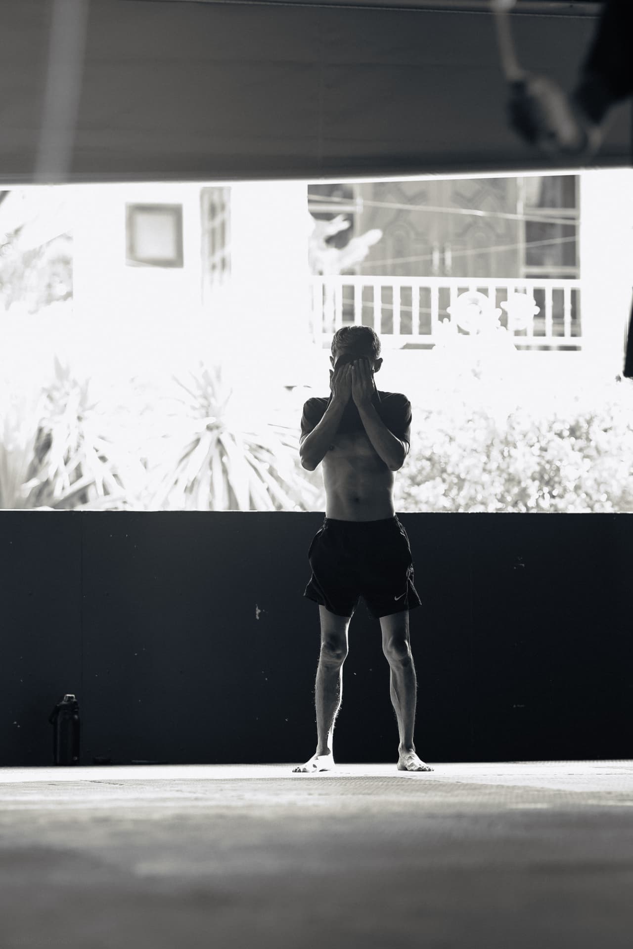 Black and white photo of a fighter shadowboxing on the open training floor