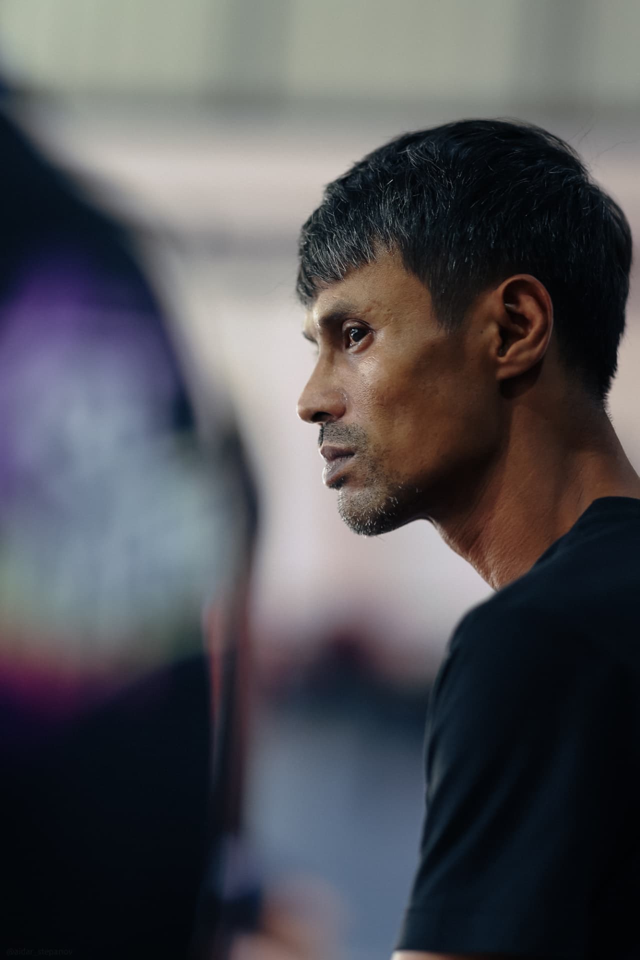 Side profile of a KRU coach watching training